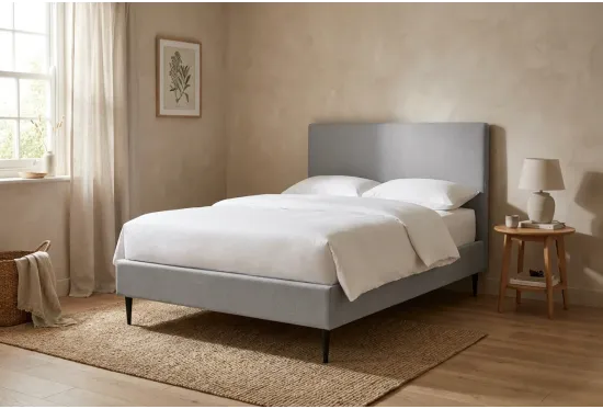 Air storage bed on legs in a calm bedroom, shown in Alpaka Cloud with an optional headboard