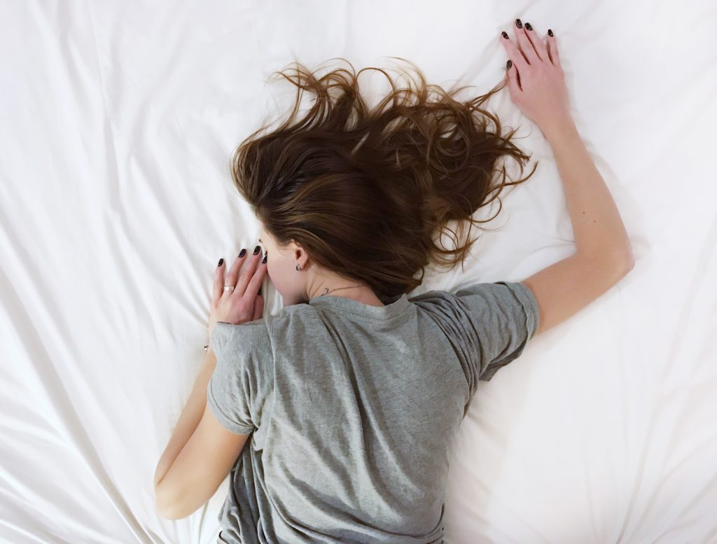 Woman sleeping on her front