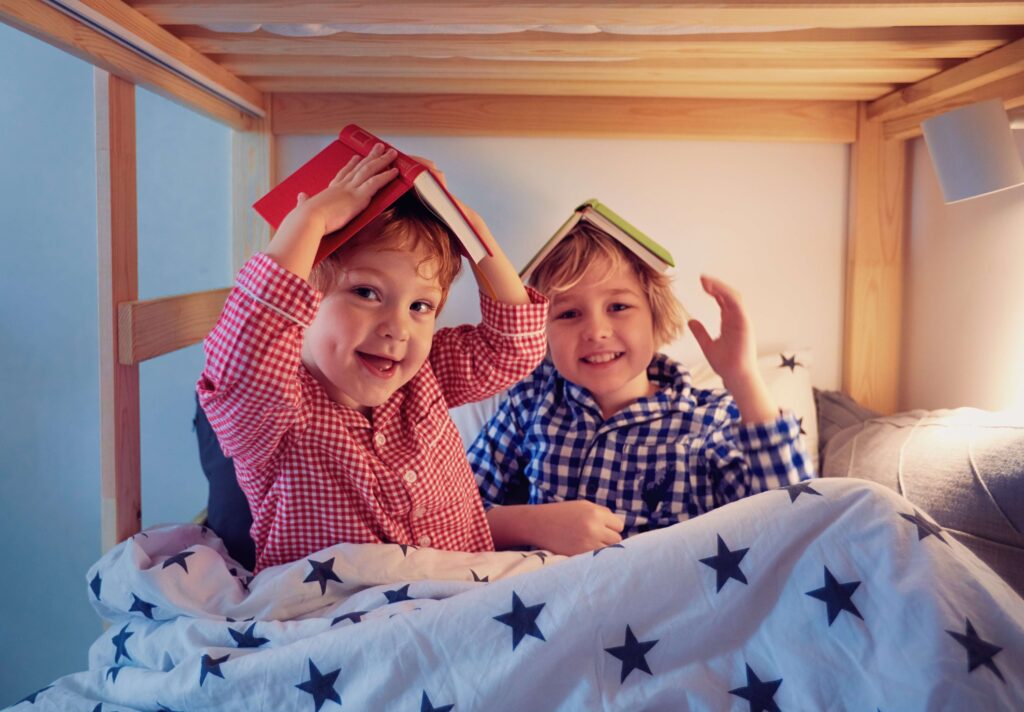 Two boys in bed with books