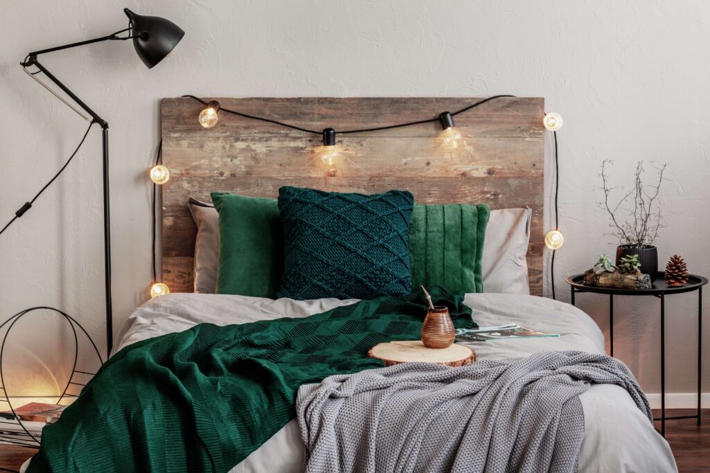 Bed with throws and wooden headboard 