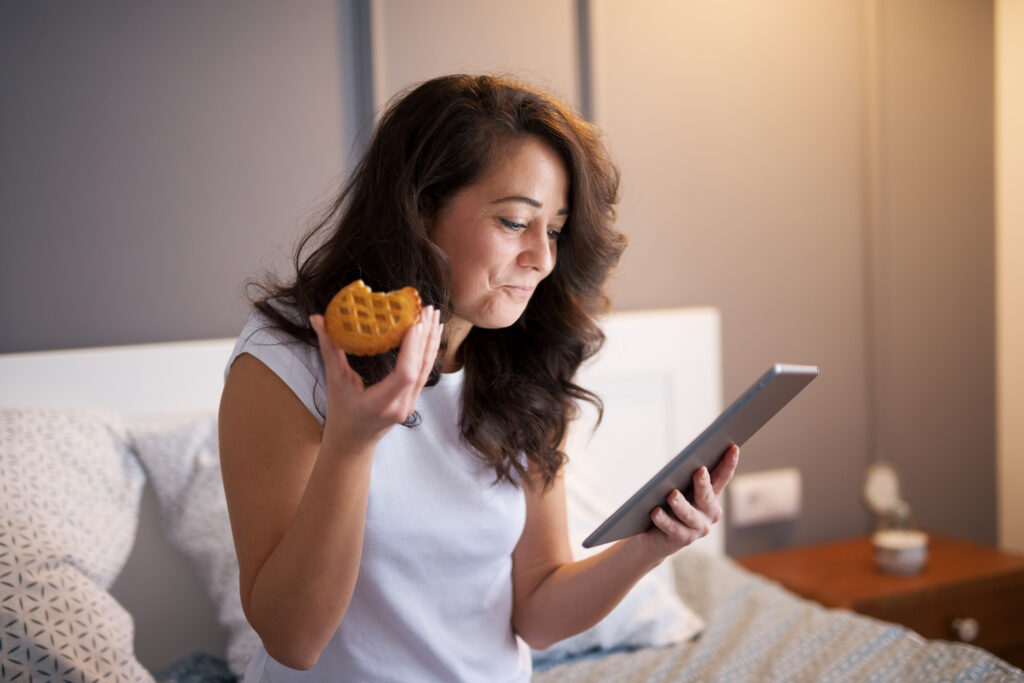 Woman eating in bed