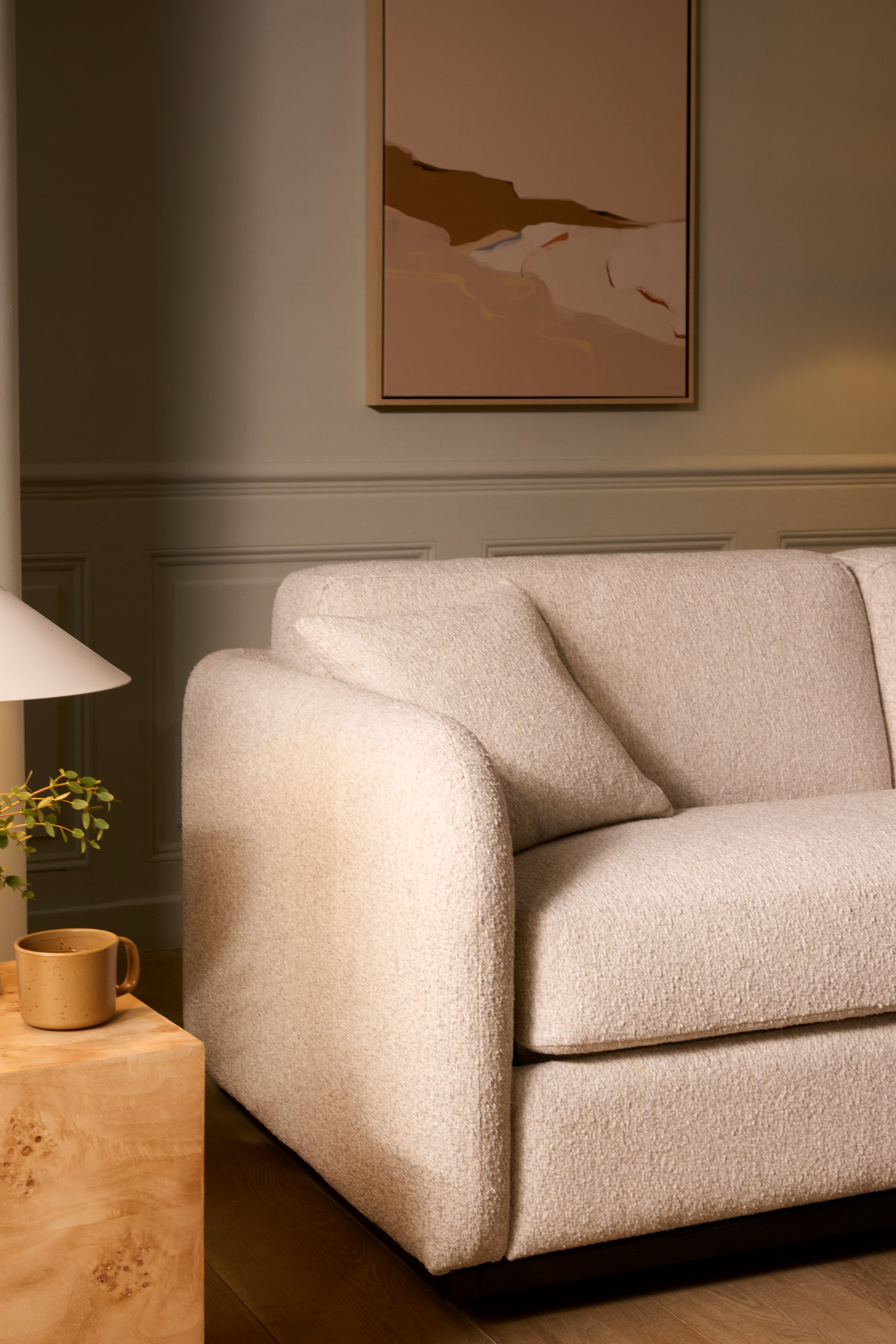 Cocoon sofa — the arm sweeping into the back in one unbroken curve