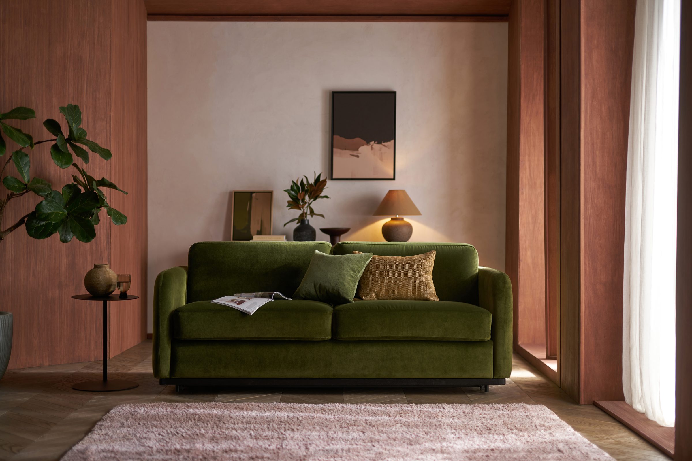 Cocoon sofa bed in forest green velvet