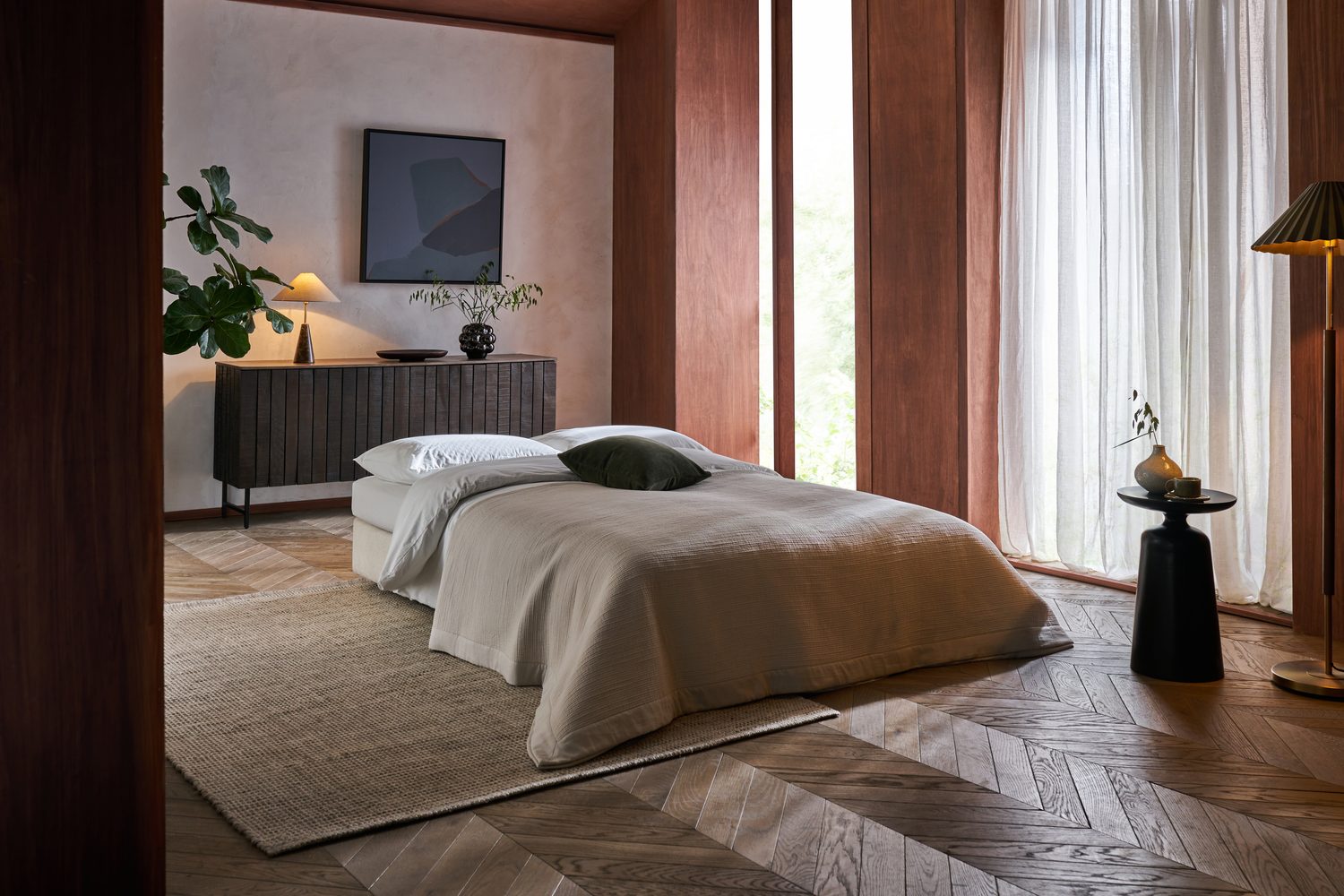 Piano sofa bed fully open — dressed as a bed