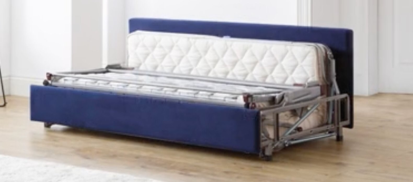 Furl sofa bed with the back removed, mechanism and mattress exposed, kickboard still attached at the front