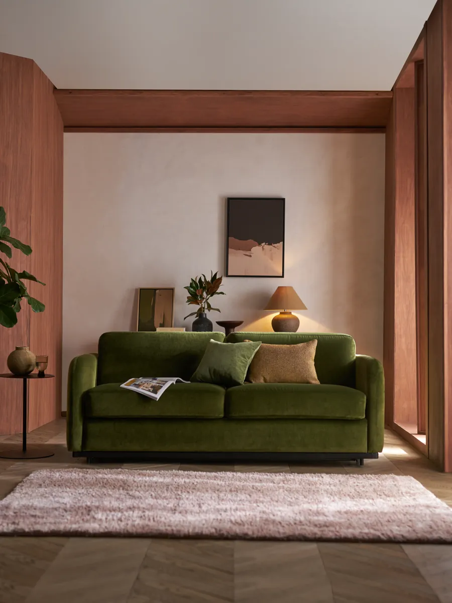 Cocoon Sofa Bed in green velvet in a calm living room