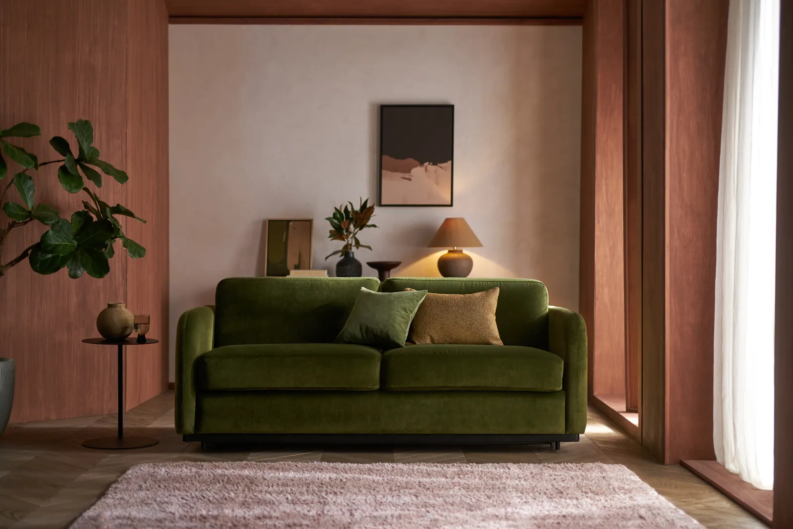Cocoon Sofa Bed in green velvet in a calm living room
