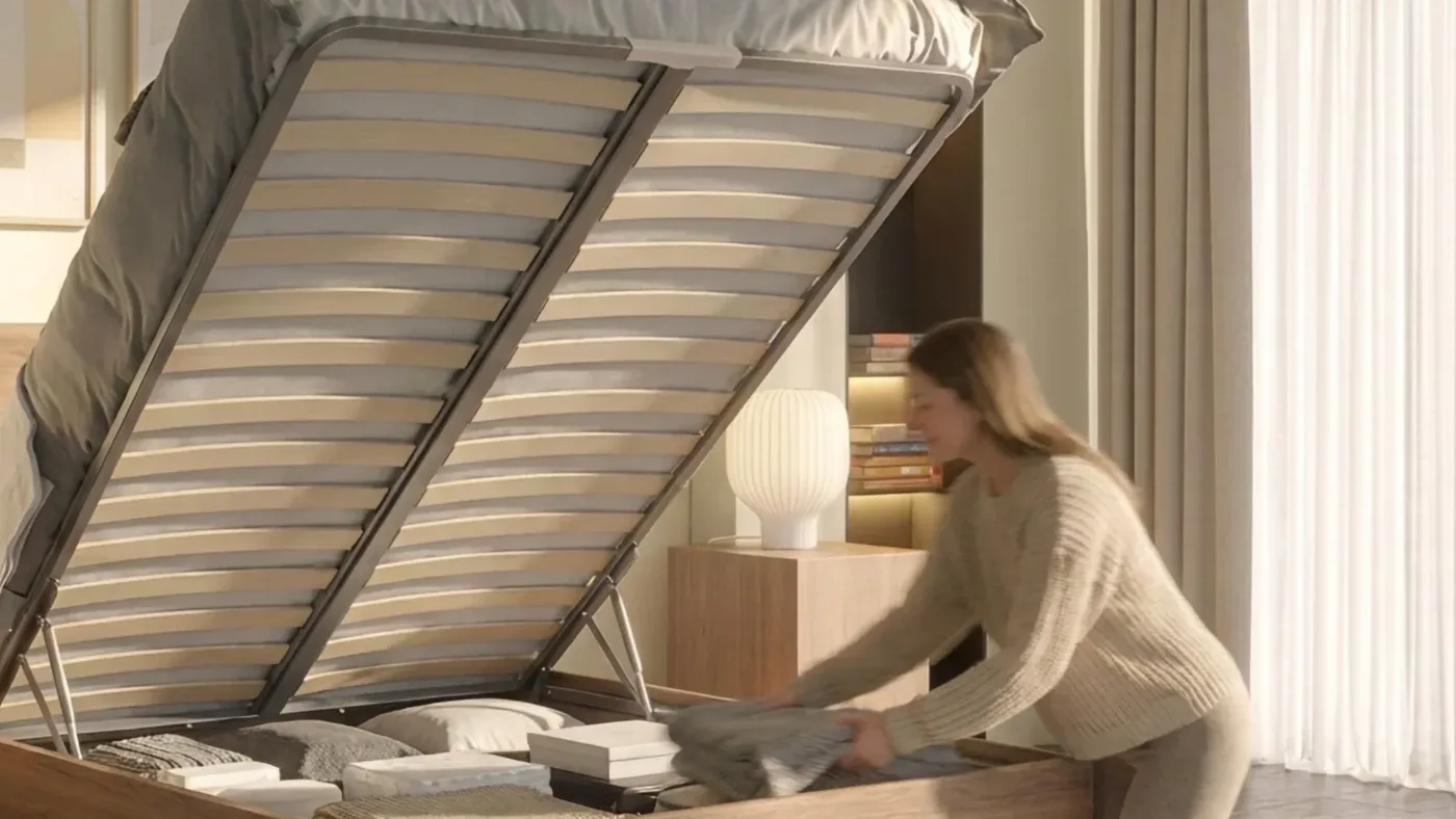 Woman putting linen away inside an open oak Air Wood ottoman bed