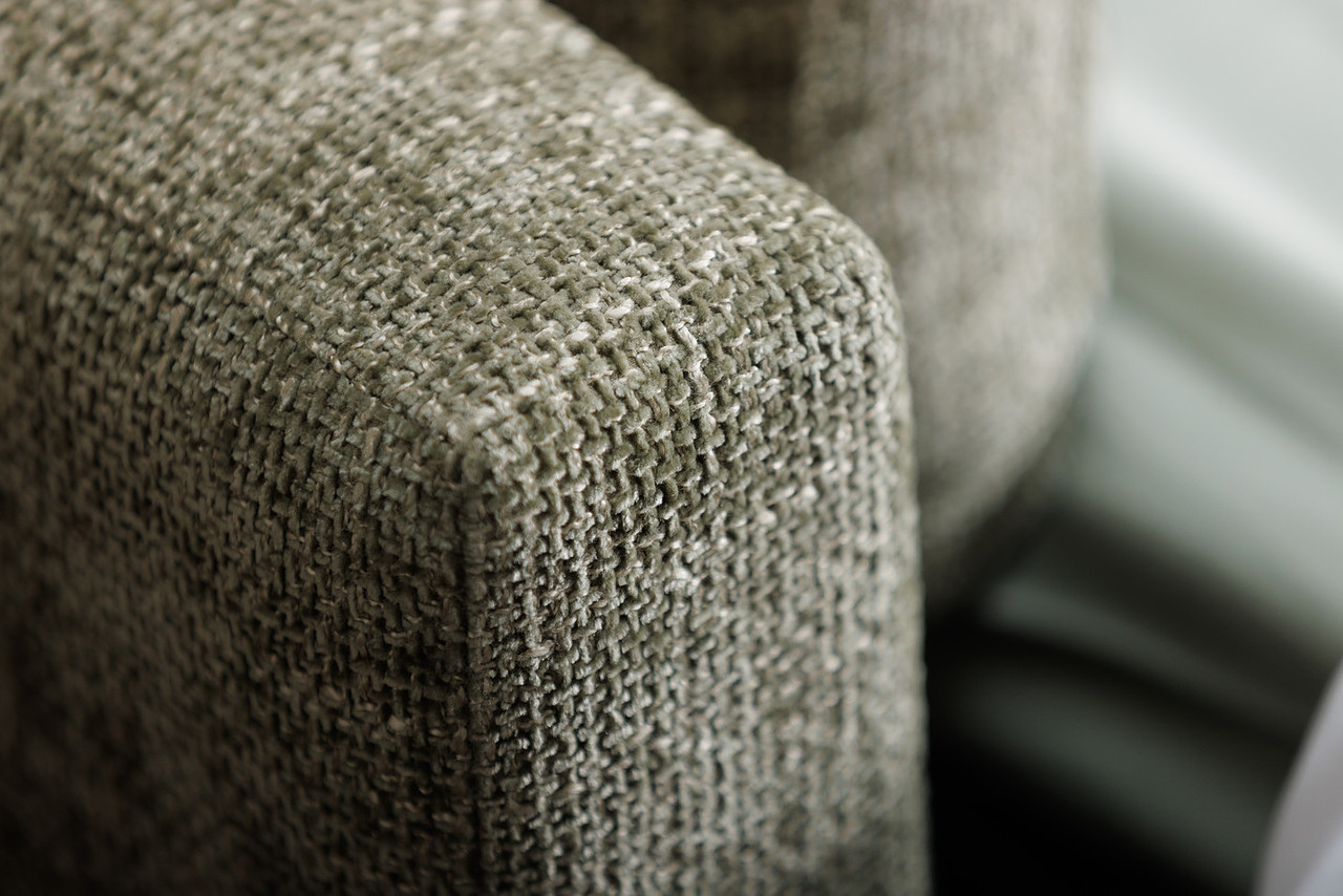 Close-up of the Sunday sofa bed — cushion and arm detail showing the soft, pillowy fill