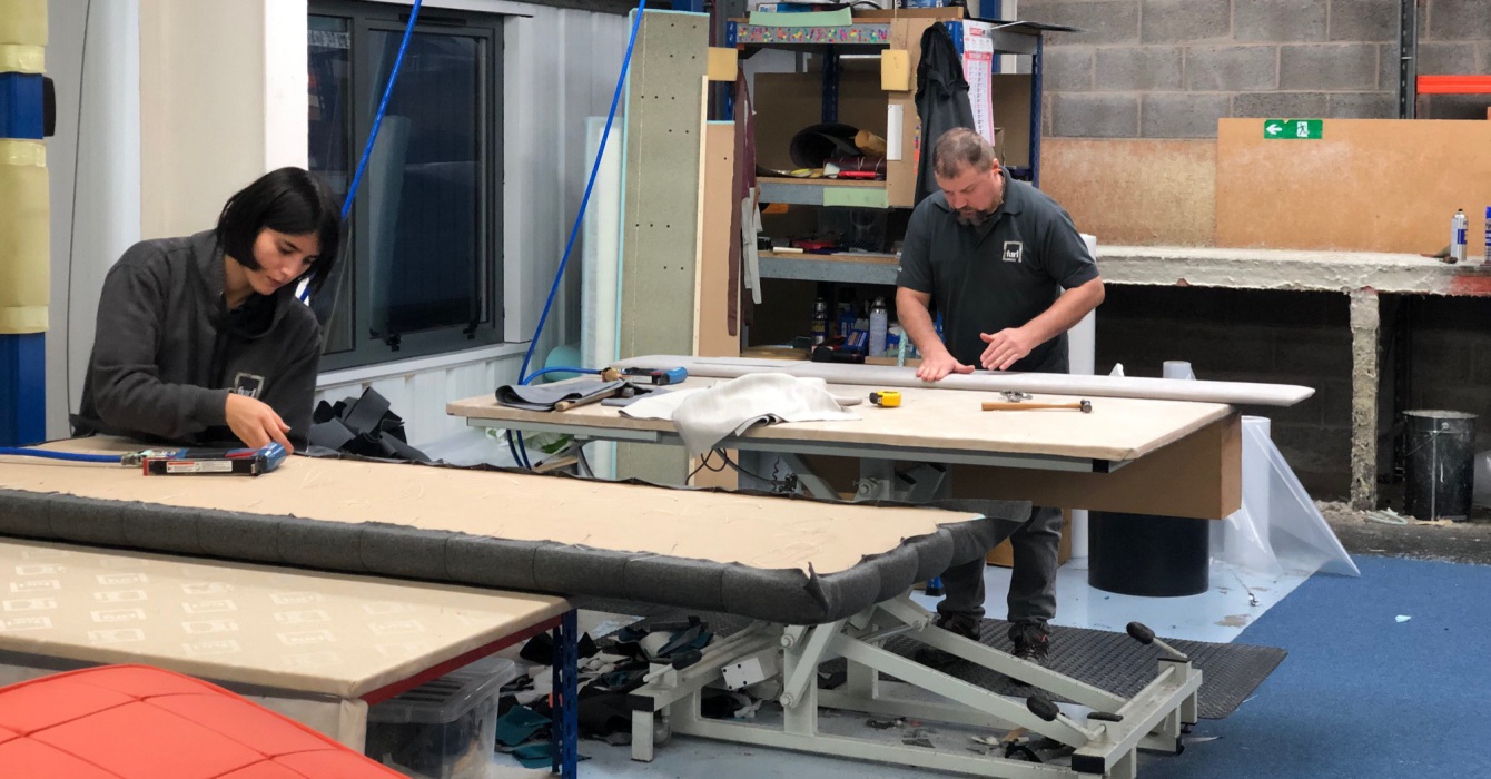 Two people manufacturing storage beds