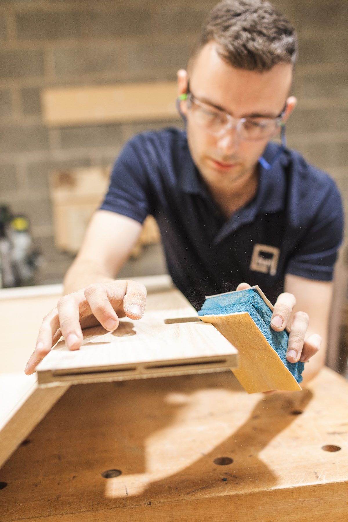 Close-up of hand finishing in the wood shop