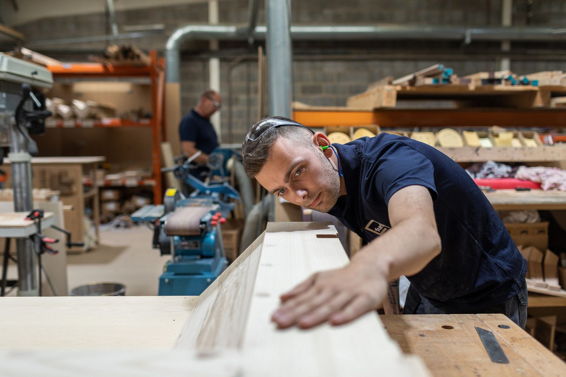 A Furl craftsman sanding a hardwood frame in our Nottingham workshop